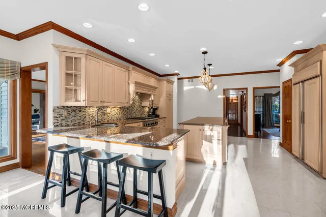 a kitchen with a table chairs refrigerator and cabinets