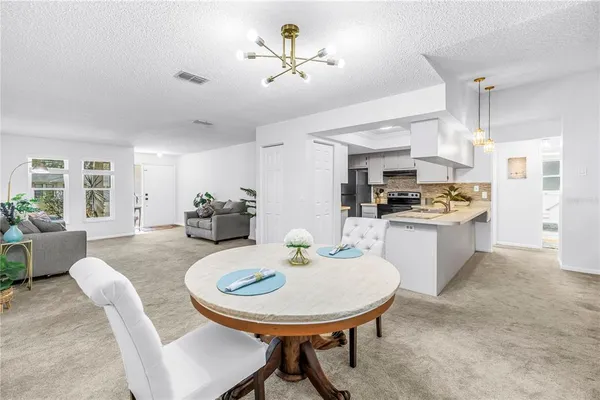 a kitchen with stainless steel appliances kitchen island granite countertop a refrigerator stove and sink