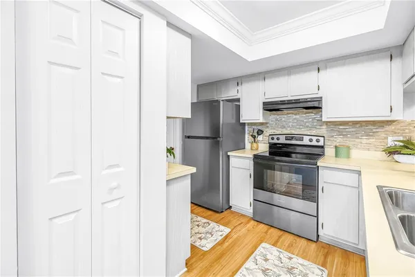 a kitchen with stainless steel appliances granite countertop a sink stove and cabinets