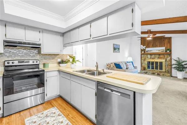 a kitchen with appliances and a refrigerator