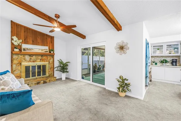 a living room with stainless steel appliances kitchen island granite countertop furniture and a lamp