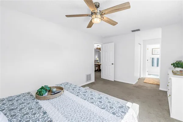 a spacious en suite bathroom with a double vanity sink and mirror
