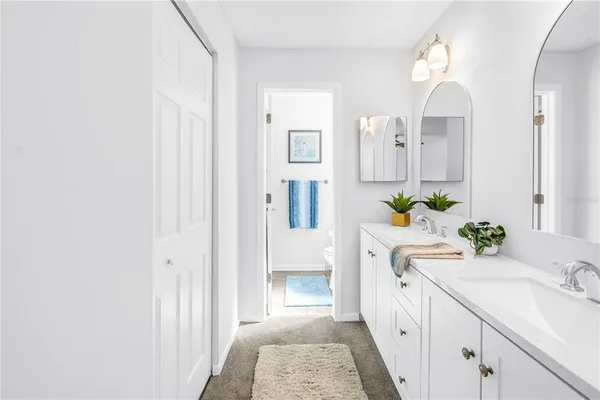 a white toilet sitting next to a bathroom sink