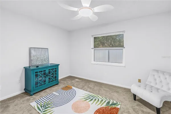 a dining room with furniture and a floor to ceiling window