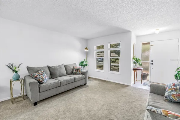 a view of a room with furniture and wooden floor