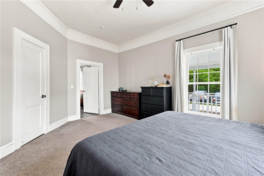 7 McCaughrin Street Pelzer, SC 29669 - Photo 11 of 24 Comfortable primary bedroom with plush carpeting and a large window inviting natural light.
