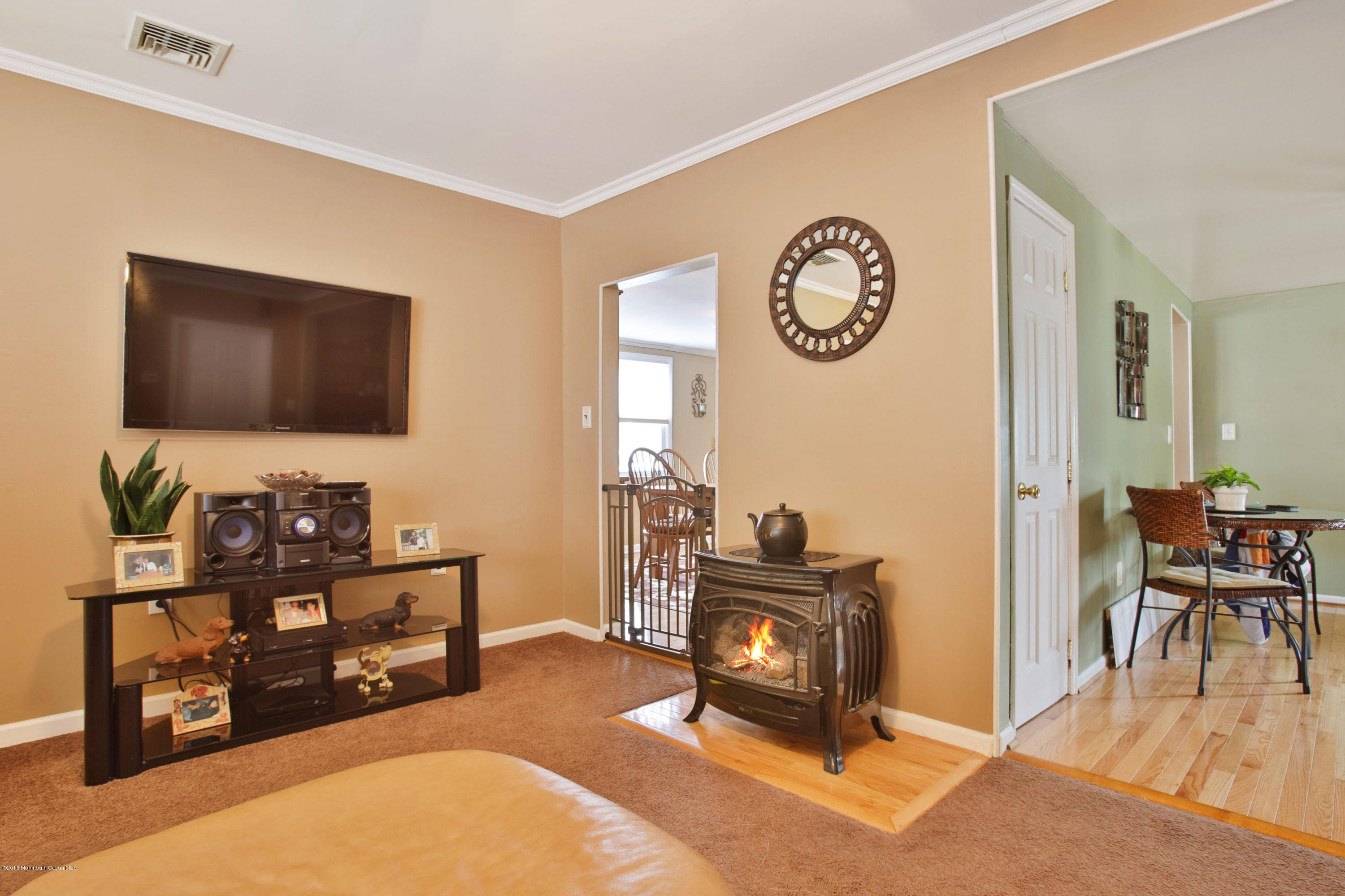 312 Florence Road Middletown, NJ 07748 - Photo 3 of 18 a living room with furniture a flat screen tv and a wall clock