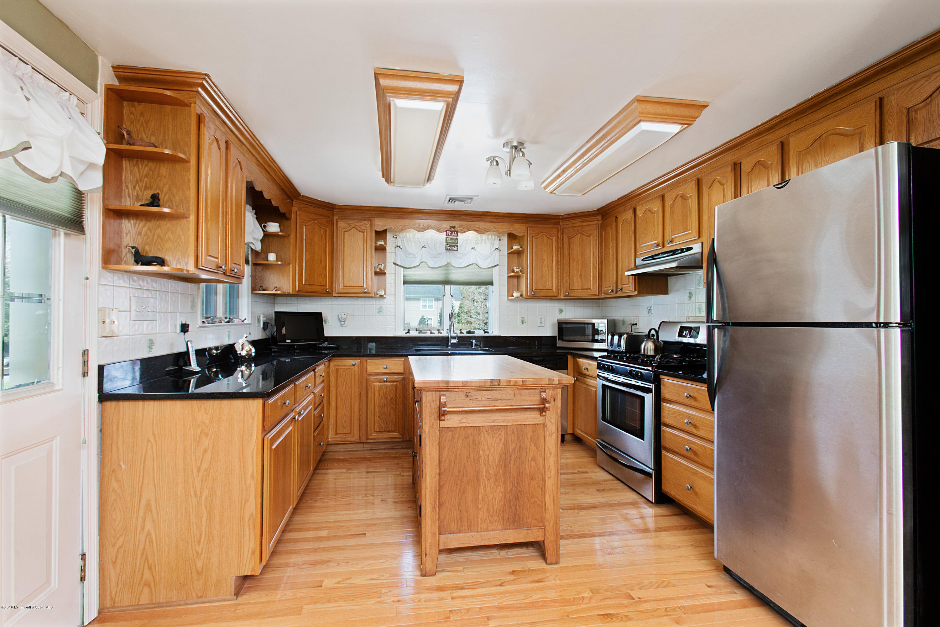 312 Florence Road Middletown, NJ 07748 - Photo 5 of 18 a kitchen with stainless steel appliances granite countertop a refrigerator a stove a sink and a microwave