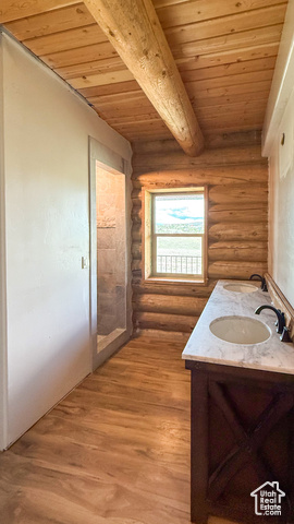 5236 North Holly Way Helper, UT 84526 - Photo 12 of 34 Bathroom with rustic walls, wooden ceiling with exposed beams, double vanity, and wood finished floors