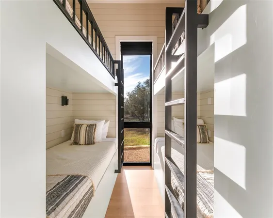 a view of a hallway with wooden floor and door