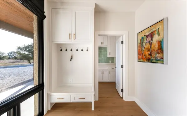 a view of a kitchen with cabinets and washer