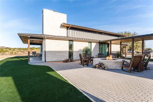 a view of a patio with dining table and chairs with a garden view