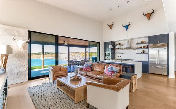 a living room with furniture and a floor to ceiling window