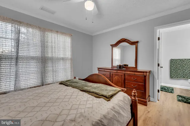 a living room with furniture and a book shelf