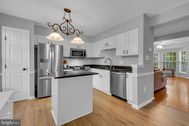 a view of a balcony with couches and wooden floor