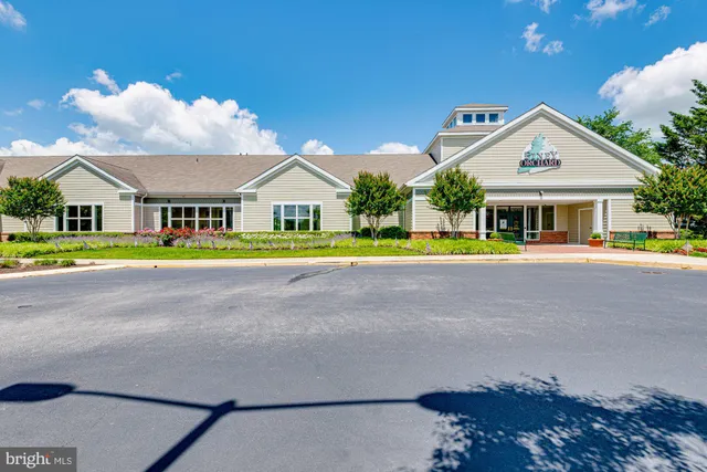 a view of a deck with a small yard and large trees