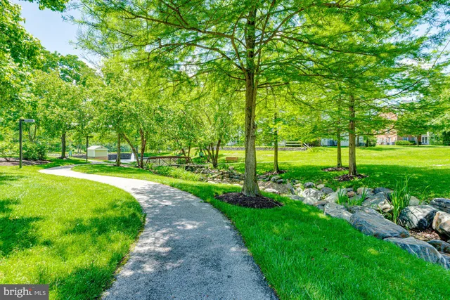 a backyard of a house with a yard and outdoor seating