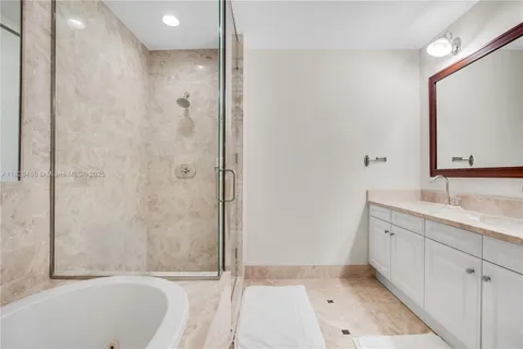 a bathroom with a granite countertop sink a toilet and shower