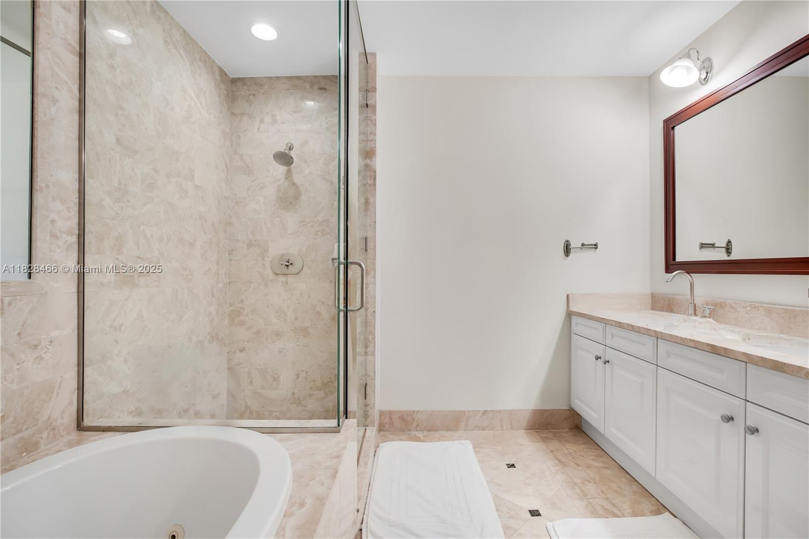 1425 Brickell Avenue, Unit 44AB Miami, FL 33131 - Photo 11 of 19 a bathroom with a granite countertop sink a toilet and shower