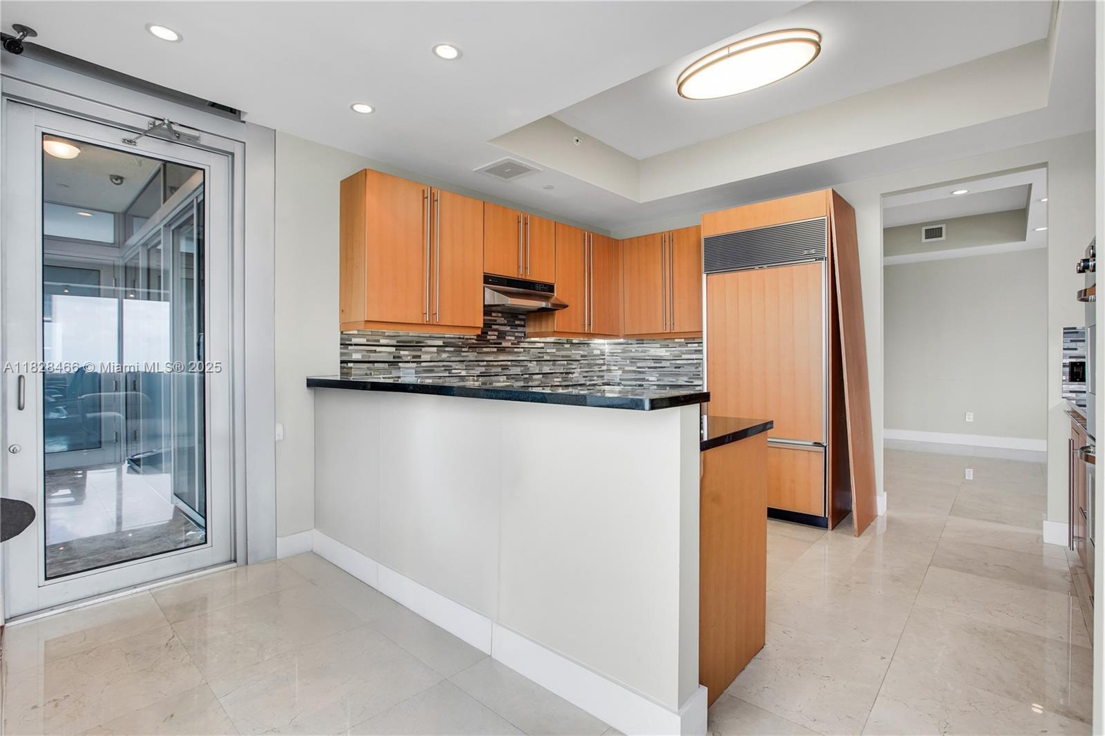 1425 Brickell Avenue, Unit 44AB Miami, FL 33131 - Photo 4 of 19 a kitchen with stainless steel appliances granite countertop a refrigerator and a sink