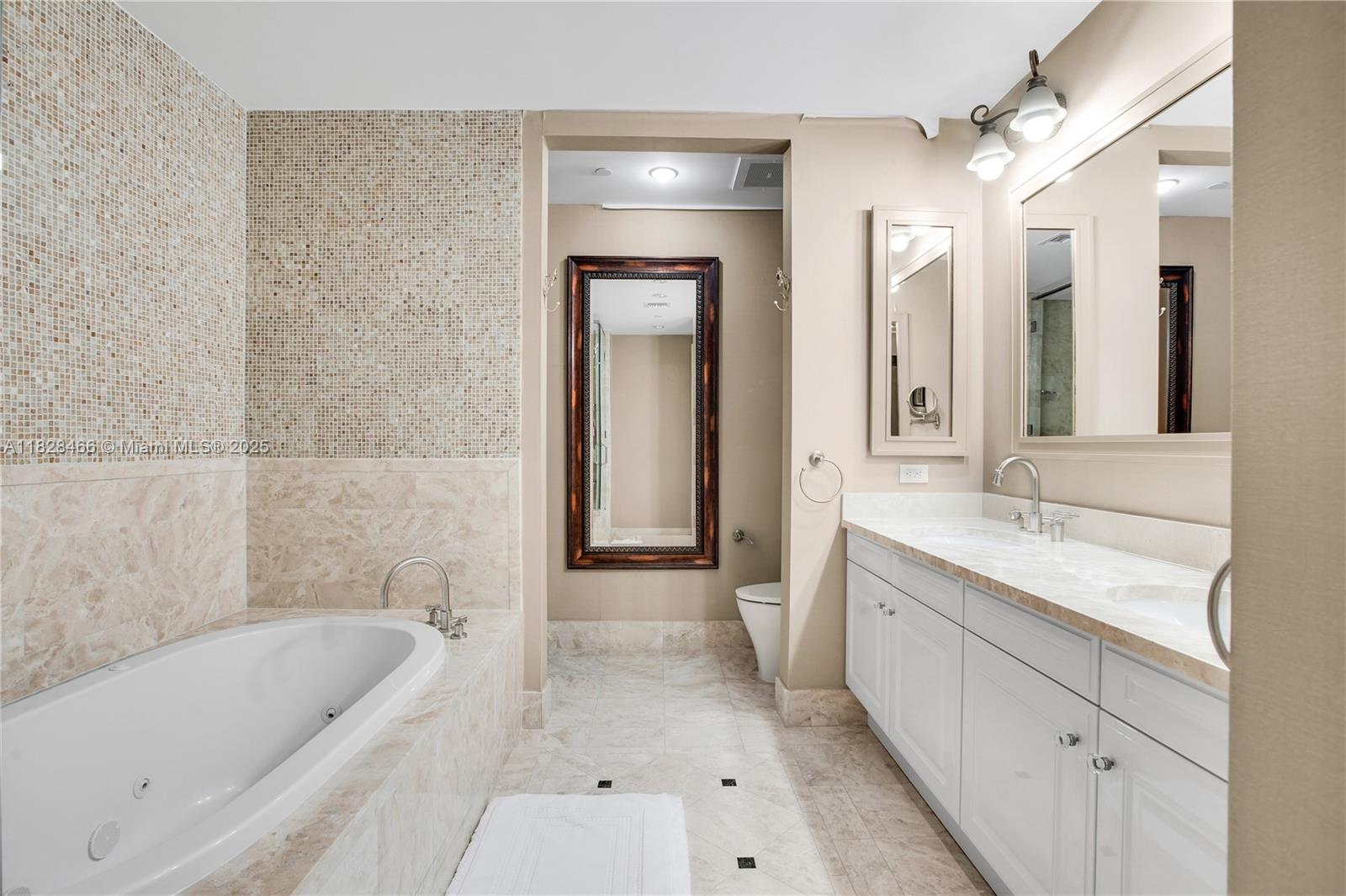 1425 Brickell Avenue, Unit 44AB Miami, FL 33131 - Photo 7 of 19 a bathroom with a tub a sink and mirror