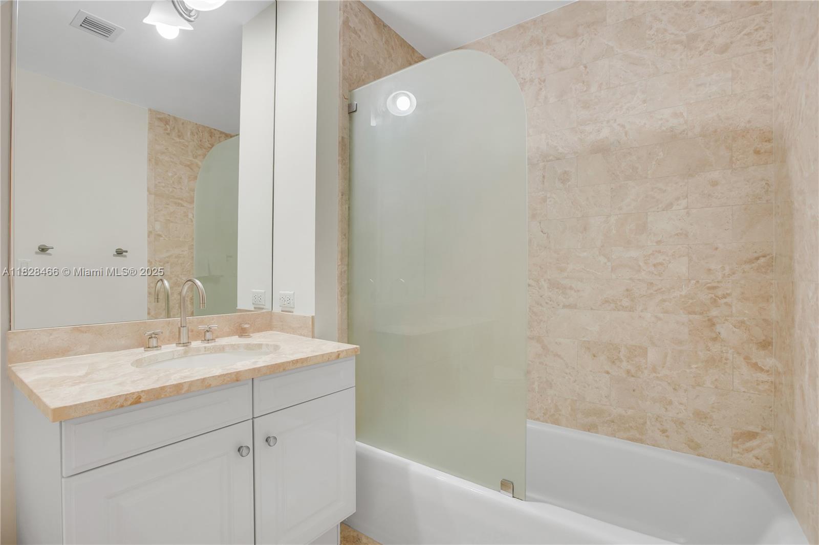 1425 Brickell Avenue, Unit 44AB Miami, FL 33131 - Photo 10 of 19 a bathroom with a sink and a bathtub