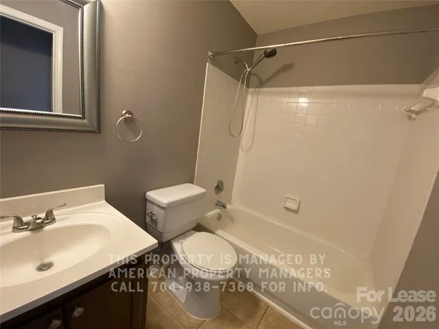 a bathroom with a sink mirror vanity and toilet