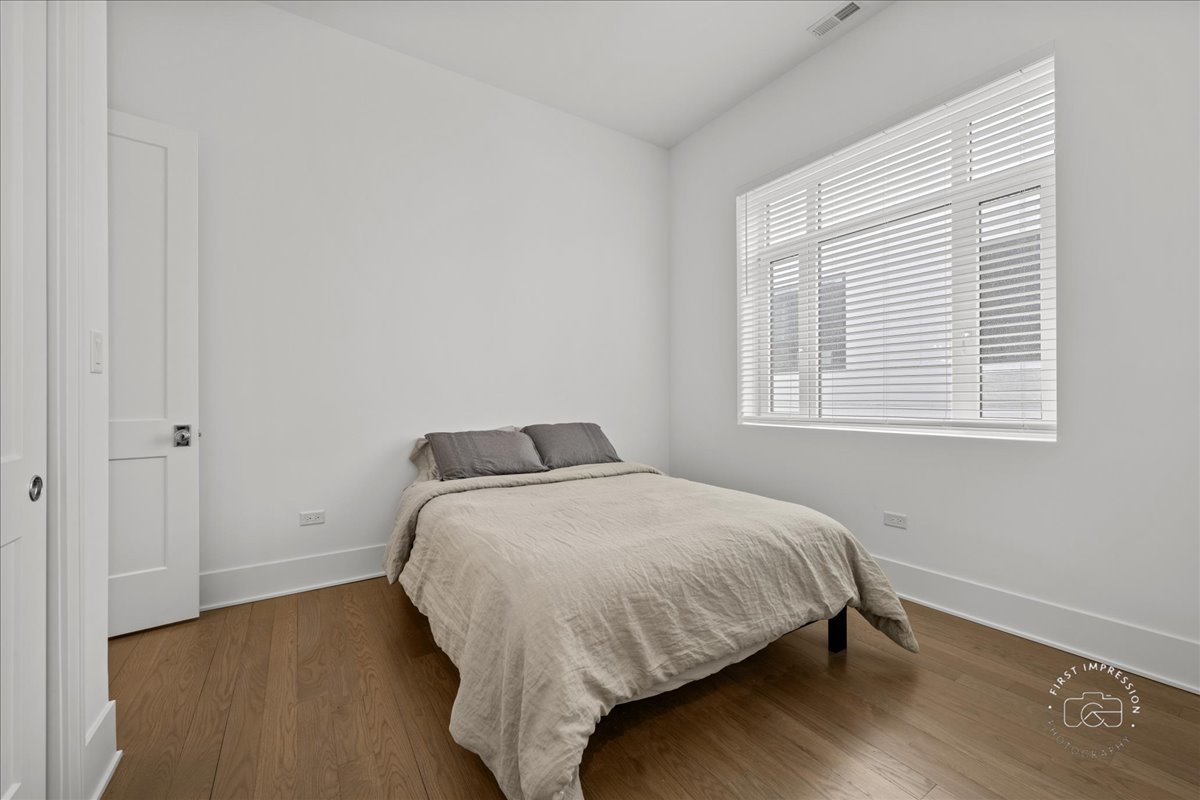 195 North Addison Avenue, Unit PH03 Elmhurst, IL 60126 - Photo 14 of 36 a bed sitting in a bedroom next to a window