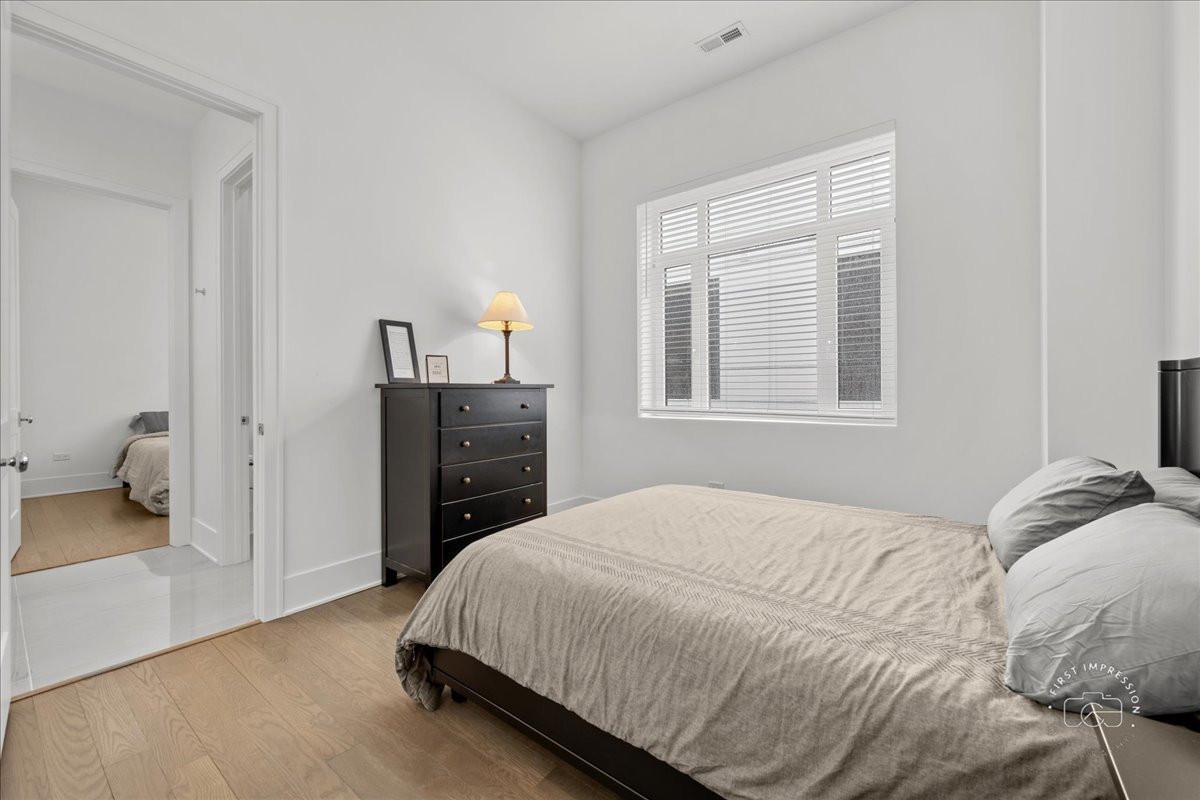 195 North Addison Avenue, Unit PH03 Elmhurst, IL 60126 - Photo 18 of 36 a bedroom with a bed and a television