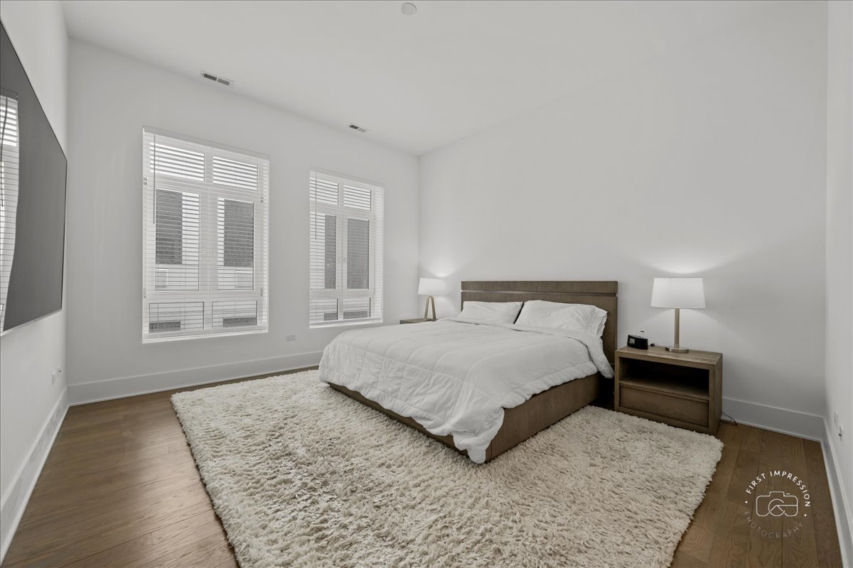 195 North Addison Avenue, Unit PH03 Elmhurst, IL 60126 - Photo 19 of 36 a bedroom with a bed and wooden floor