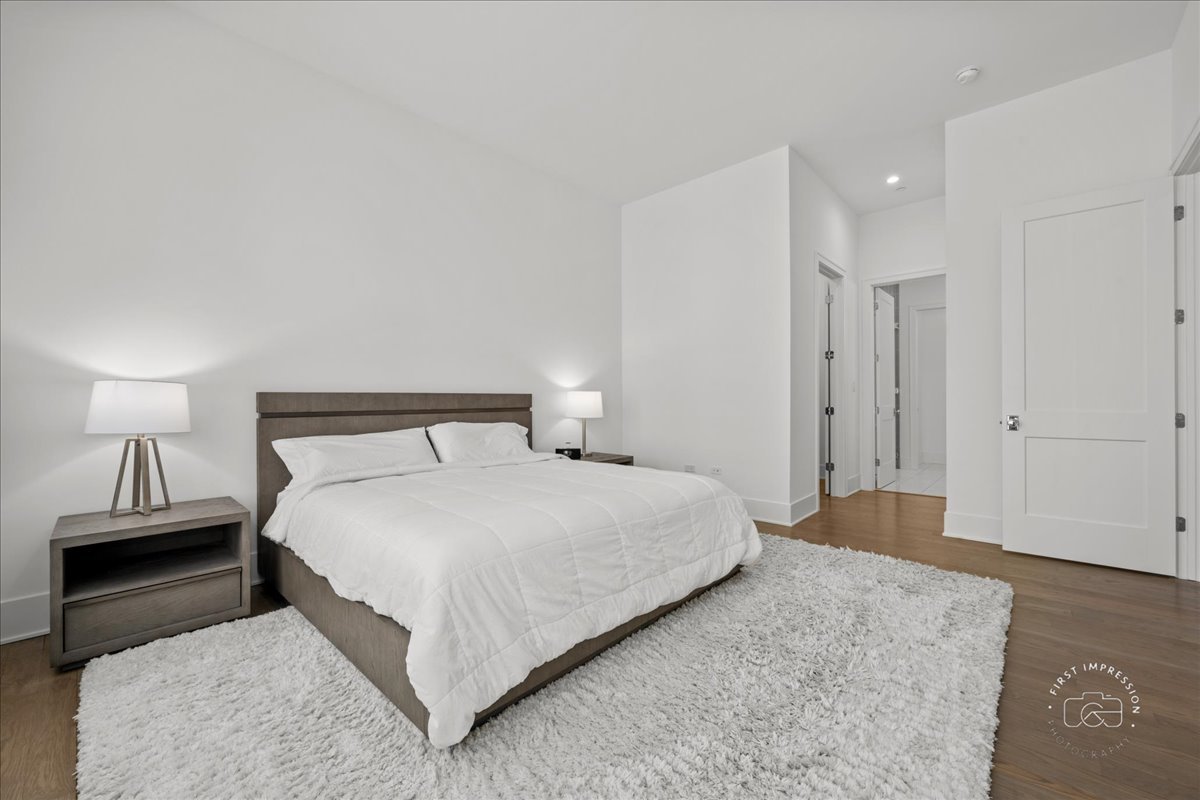 195 North Addison Avenue, Unit PH03 Elmhurst, IL 60126 - Photo 20 of 36 a bedroom with a bed and a night stand