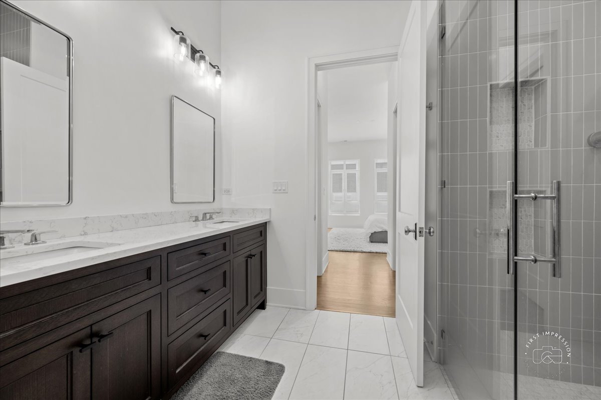 195 North Addison Avenue, Unit PH03 Elmhurst, IL 60126 - Photo 22 of 36 a bathroom with a double vanity sink shower and a mirror