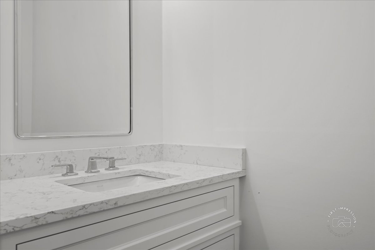 195 North Addison Avenue, Unit PH03 Elmhurst, IL 60126 - Photo 26 of 36 a bathroom with a sink and a mirror