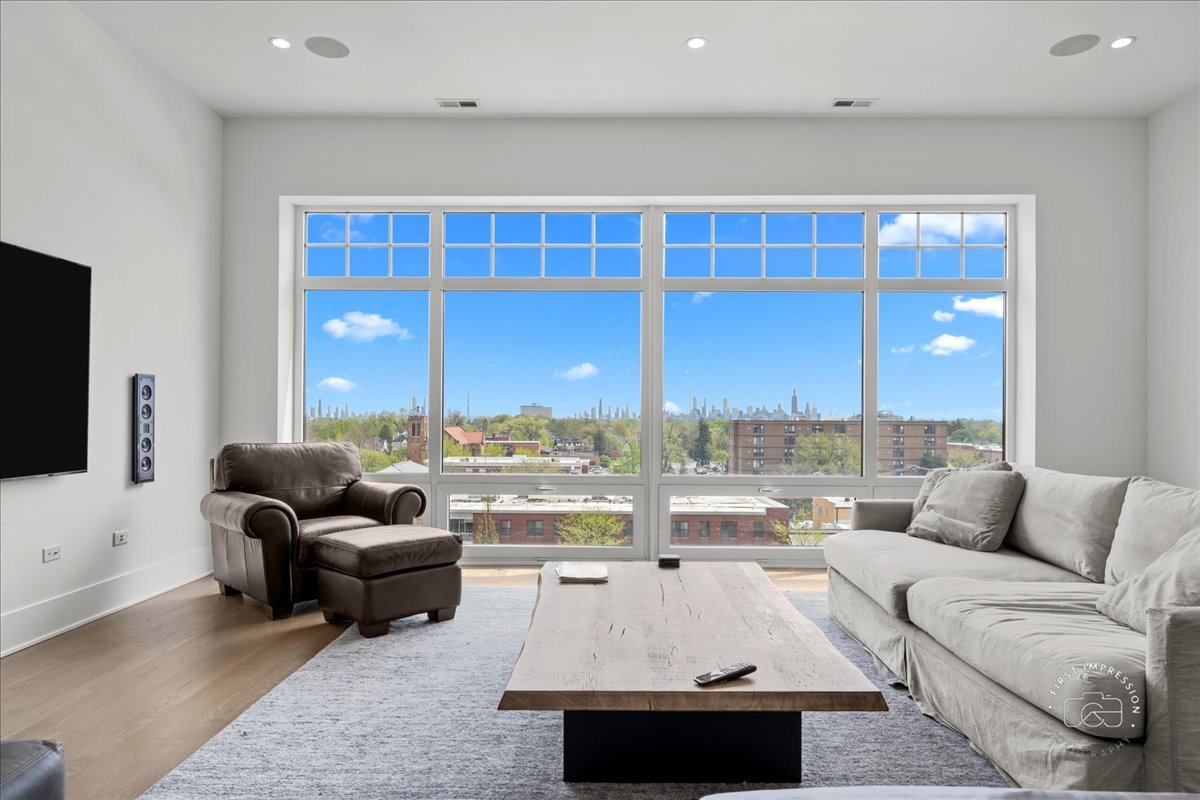 195 North Addison Avenue, Unit PH03 Elmhurst, IL 60126 - Photo 8 of 36 a living room with furniture and a flat screen tv