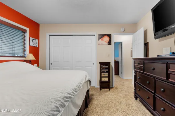 a bedroom with a bed and flat screen tv