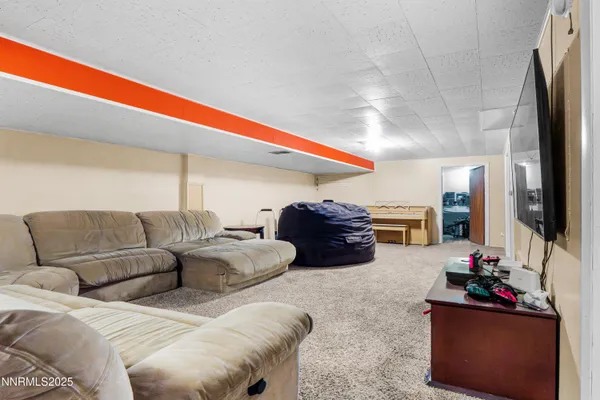 a bedroom with furniture and a fan