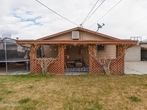 a white house with a big yard and large trees