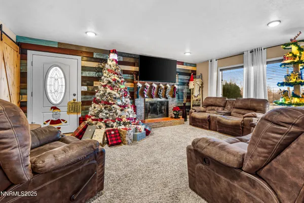 a living room with furniture a flat screen tv and a large window