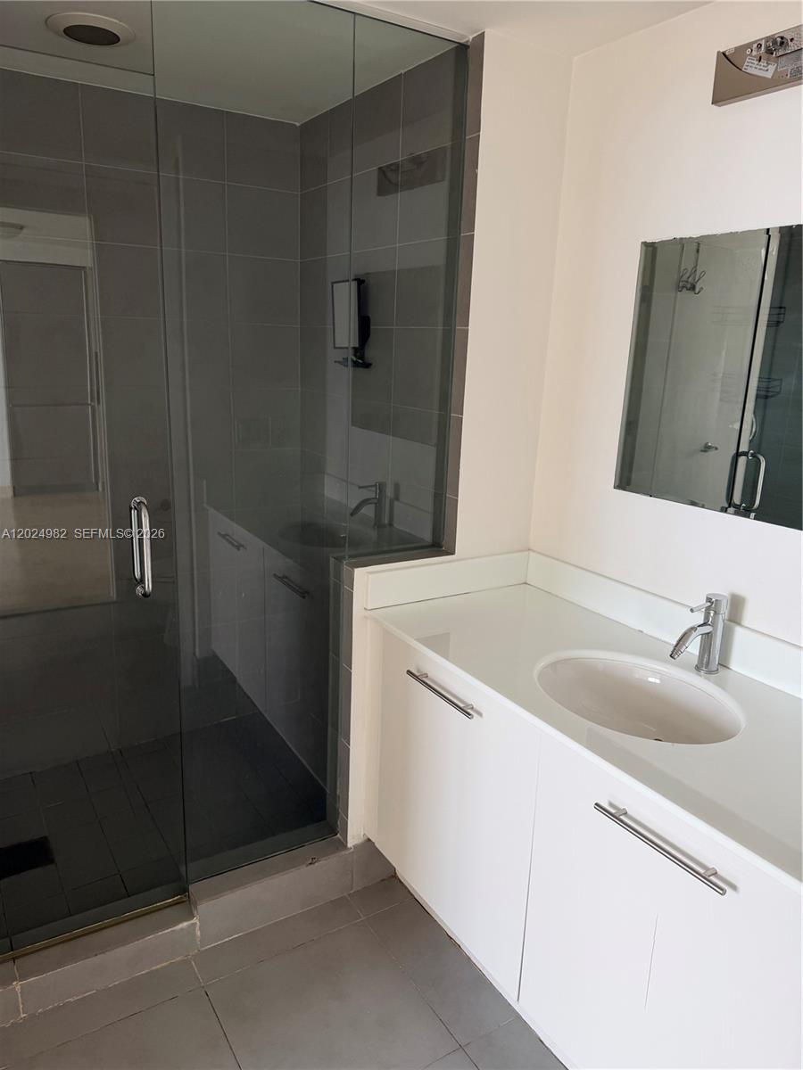 92 Southwest 3rd Street, Unit 3909 Miami, FL 33130 - Photo 5 of 13 a bathroom with a sink and a mirror