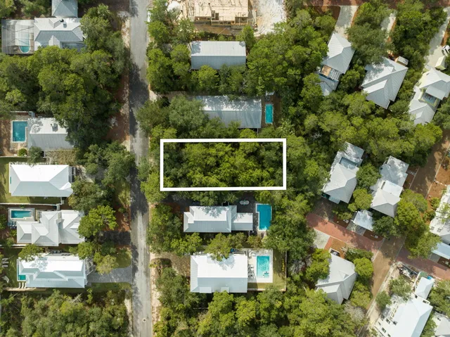an aerial view of a house with swimming pool and garden
