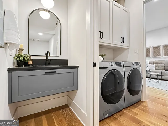 a utility room with sink dryer and washer