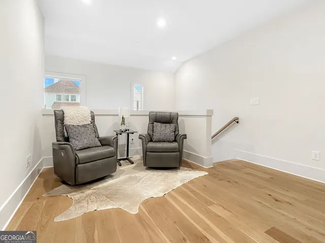 a living room with a couch and a wooden floor