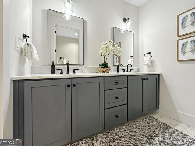 a bathroom with a double vanity sink mirror and