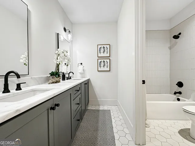a bathroom with a tub sink and mirror