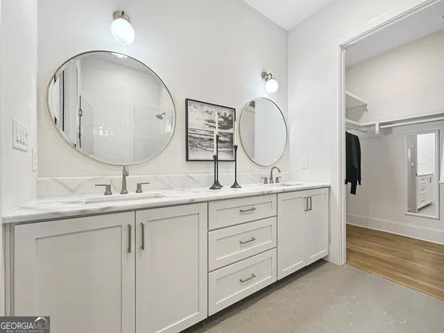 a bathroom with a double vanity sink and a mirror