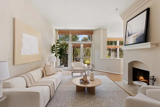 a living room with furniture and a fireplace