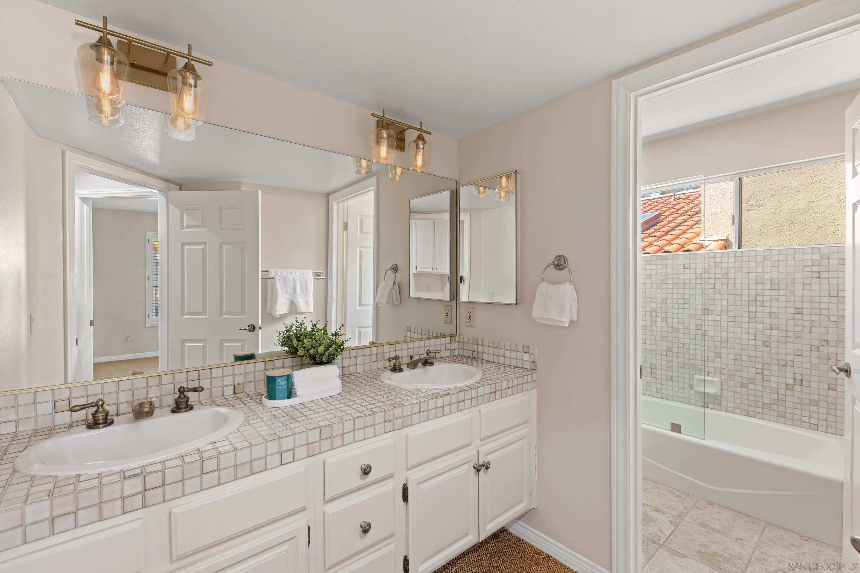 1466 Caminito Solidago La Jolla, CA 92037 - Photo 22 of 62 a bathroom with a granite countertop sink mirror and a bathtub