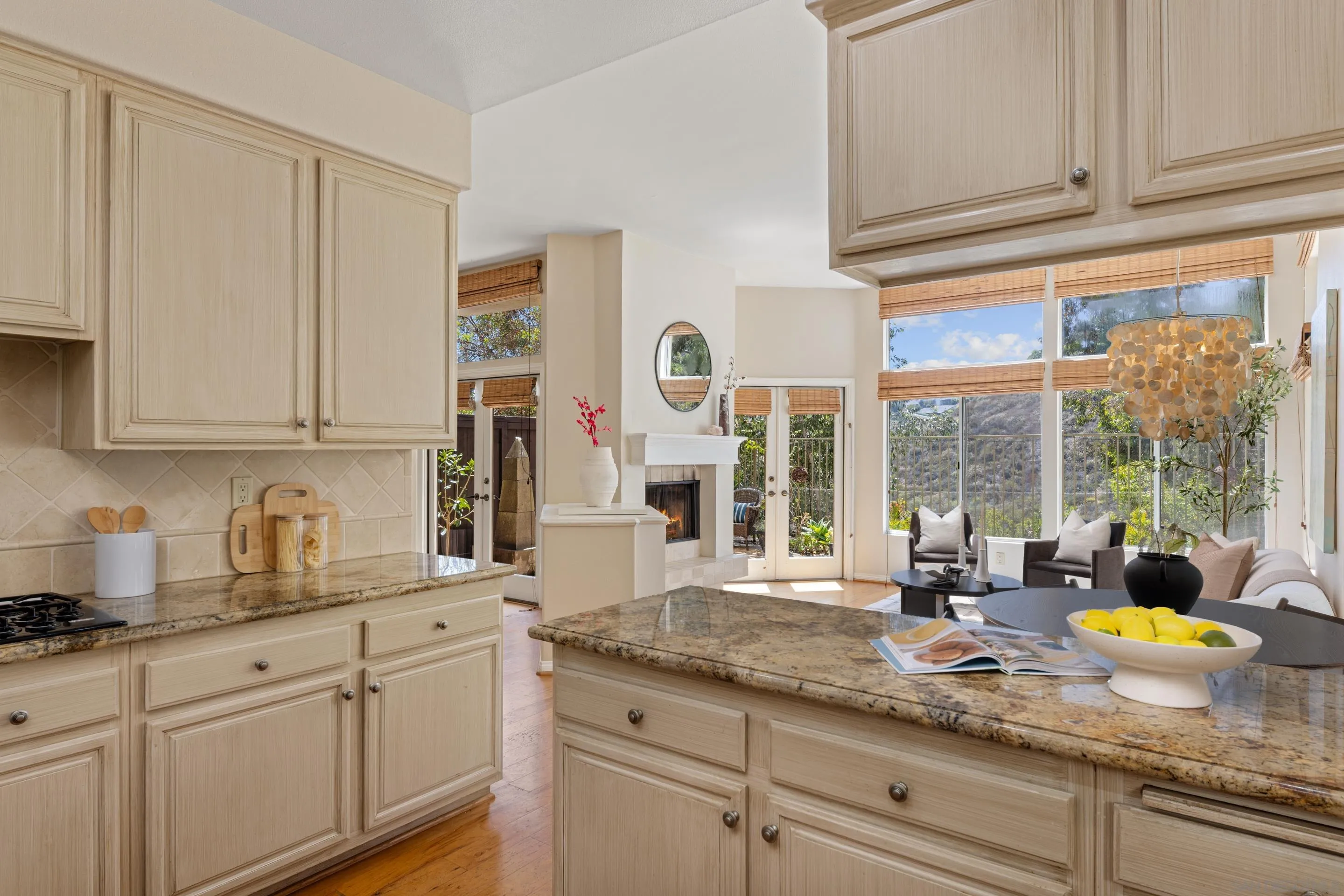 1466 Caminito Solidago La Jolla, CA 92037 - Photo 9 of 62 a kitchen with granite countertop stainless steel appliances white cabinets and a window