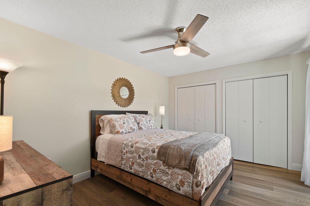 3900 County Line Road, Unit 22A Tequesta, FL 33469 - Photo 35 of 51 a bedroom with a bed and a chandelier