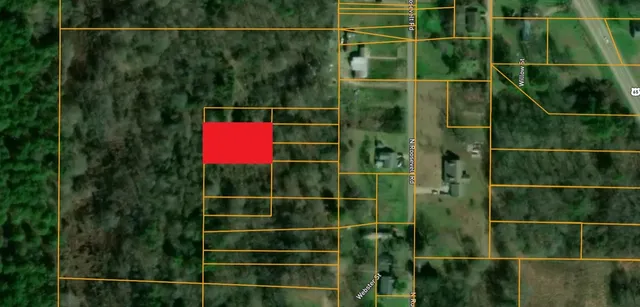 a view of a fence and house next to a yard